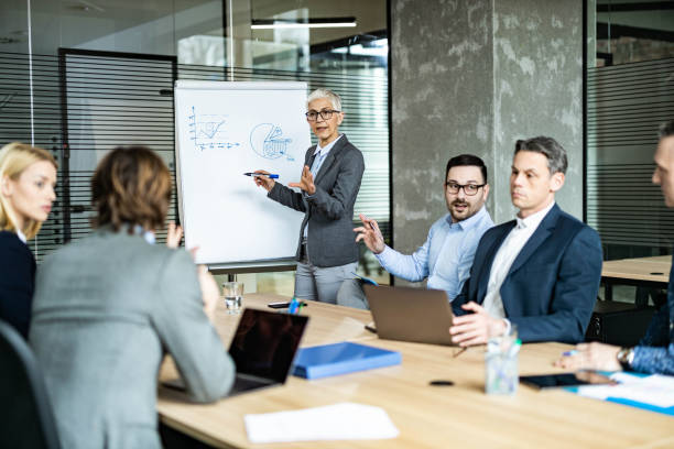 istock Mature CEO talking to her team during a presentation in the office. 1324166668