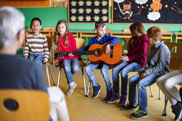istock Large group of elementary students having a music class at school. 1324167689