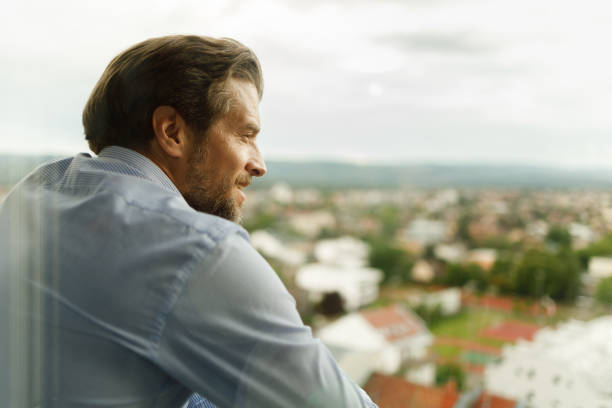 istock Happy businessman day dreaming on a terrace. 1324170136