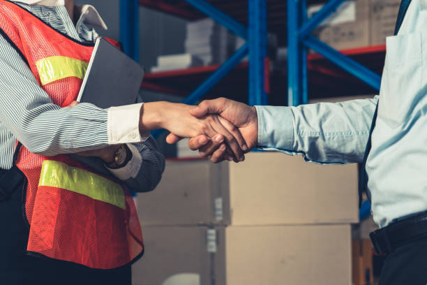 istock Warehouse worker handshake with manager in storehouse 1324170291