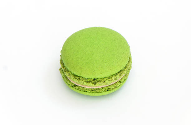 istock Green macaroon on white background. High definition photo in close up. 1324170585