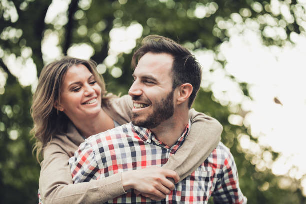 istock Young happy couple having fun while piggybacking in springtime. 1324170649