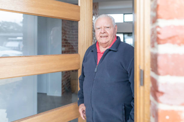 istock Senior Man Opening the Front Door at Home 1324171493