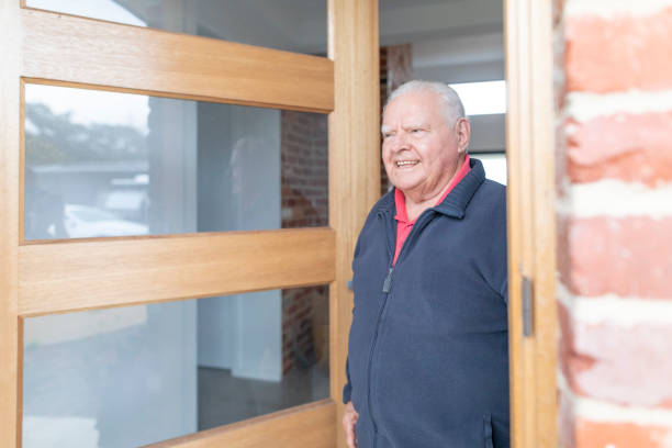 Senior Man Opening the Front Door at Home
