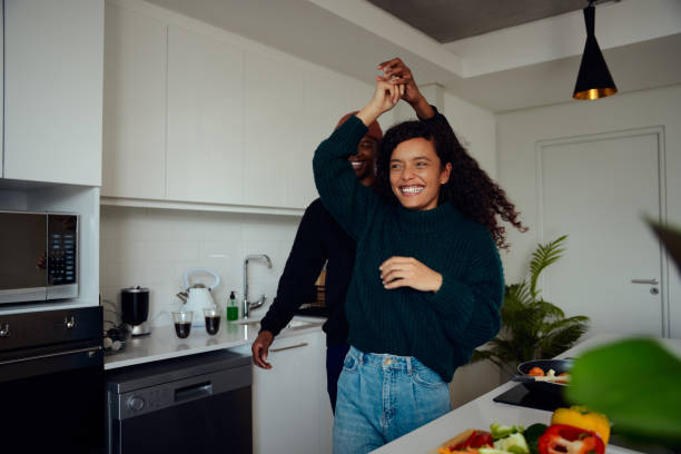 mixed race couple having fun in the kitchen. mixed race couple dancing together. high quality photo - couple african descent loving young adult imagens e fotografias de stock