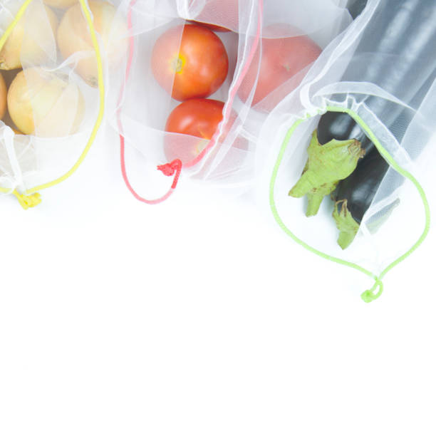 istock Vegetables in the grocery mesh on a white background. Copy space, flat lay. Zero waste concept. 1324172643