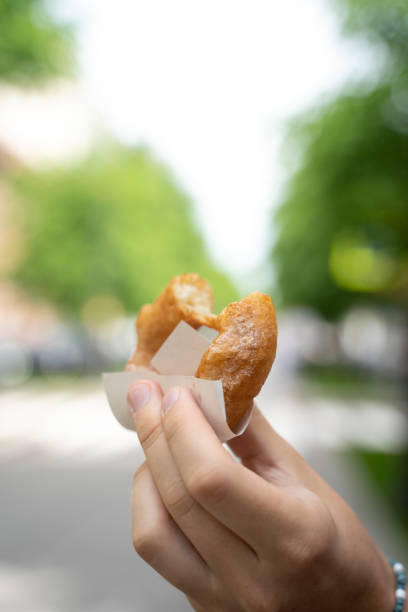 istock A man eats legendary crumpets in St. Petersburg 1324174857