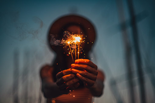 Young Woman Holding Sparkler