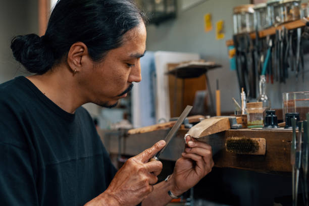 istock Mid adult silversmith polishing a silver ring by hand 1324177484