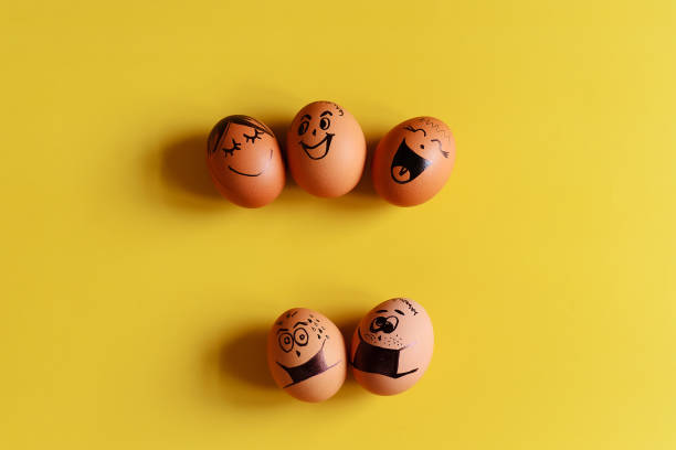 istock Creative Easter eggs with Corona virus (COVID19) protection concepts. Diverse chicken eggs with doodle faces wearing medical masks on yellow background. Flat lay, top view, mockup, copy space. 1324179222