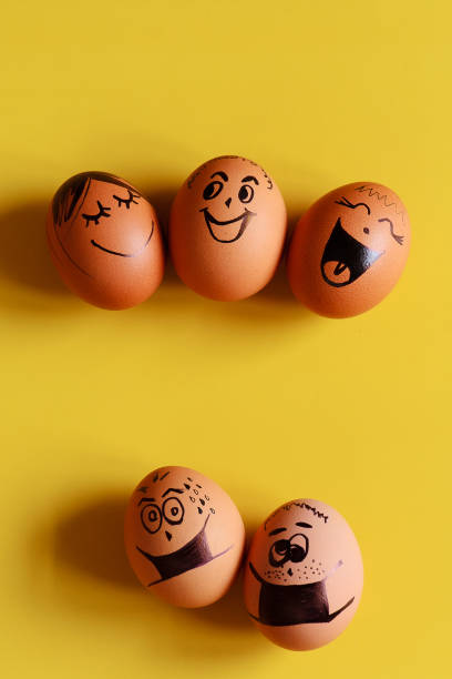 istock Creative Easter eggs with Corona virus (COVID19) protection concepts. Diverse chicken eggs with doodle faces wearing medical masks on yellow background. Flat lay, top view, mockup, copy space. 1324179272