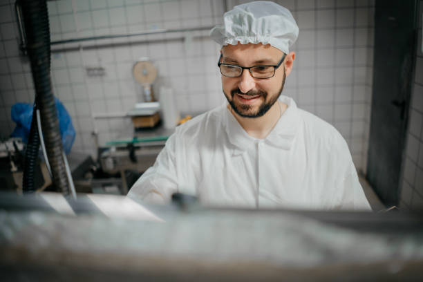 istock Technologist expert taking parameters from industrial machine in a milk factory 1324180777
