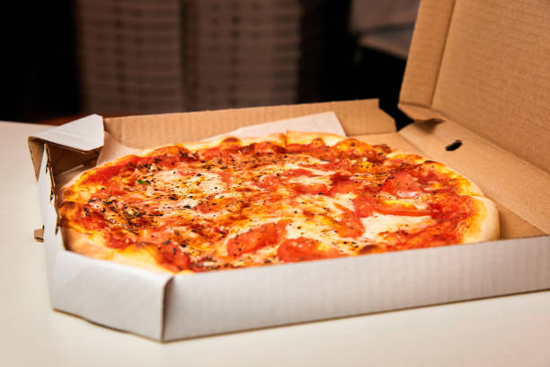 istock Pizza in an open box prepared for delivery 1324183666