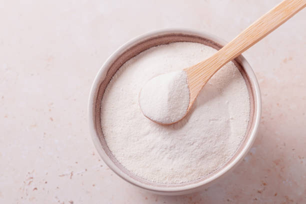 istock Collagen powder and spoon on beige stone background, top view 1324185001