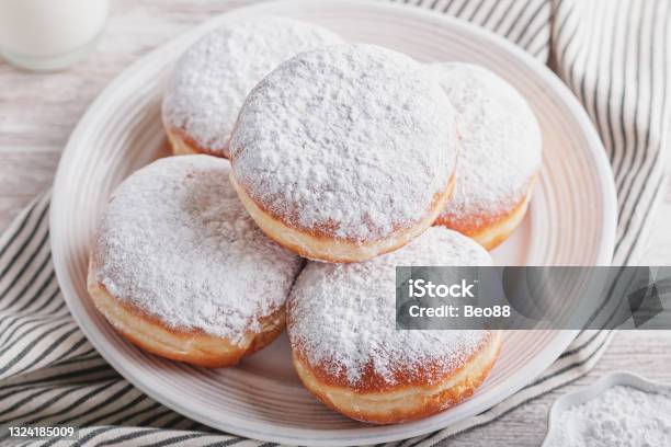 Delicious Strawberry Jam Filled Berliner Doughnuts On White Plate And Glass Of Milk On Wooden Table Top Overhead Stock Photo - Download Image Now