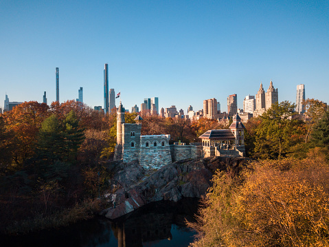 Central Park and Belvedere Castle in New York City between the Upper West and Upper East Sides of Manhattan in the United States of America aerial view. Autumn landscape with orange fall foliage