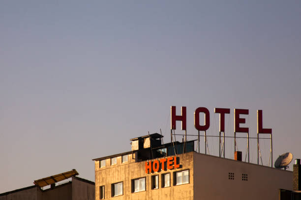 istock Hotel signs on building facade, clear sky background. 1324186766