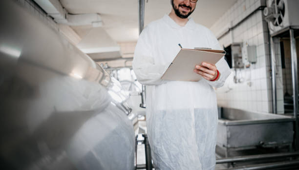istock A worker in a food factory writes notes 1324186813