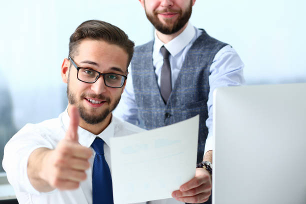 istock Happy male colleagues rejoicing at success at work 1324186950