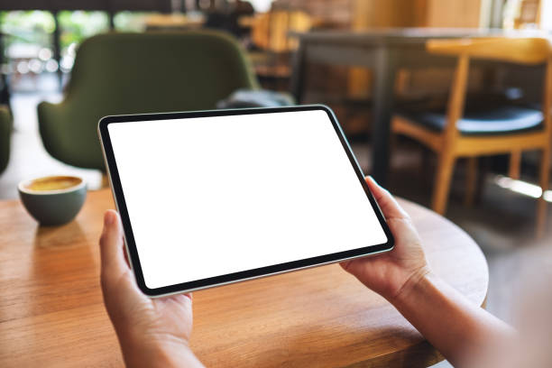 istock a woman holding digital tablet with blank white desktop screen 1324188177