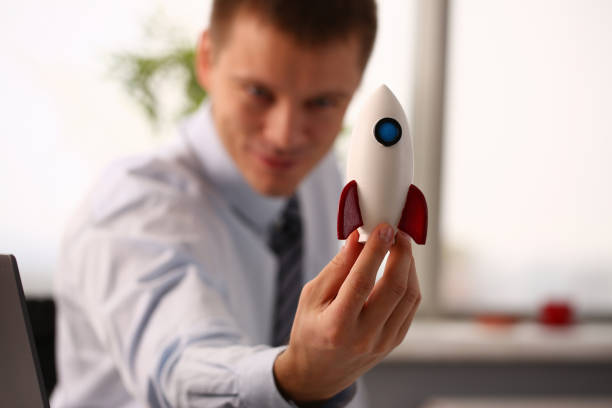 istock Cheerful manager holding plastic missile in office 1324189261