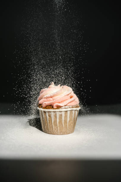 istock Cupcake on a dark background, which is sprinkled on top. 1324189413