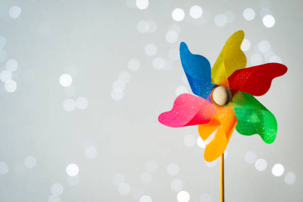 istock Colorful pinwheel on shiny white background with bokeh 1324189750