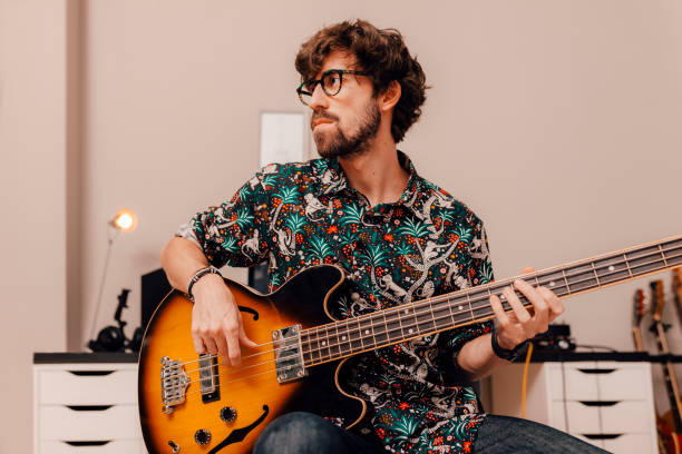 istock Musician plays bass guitar 1324190595