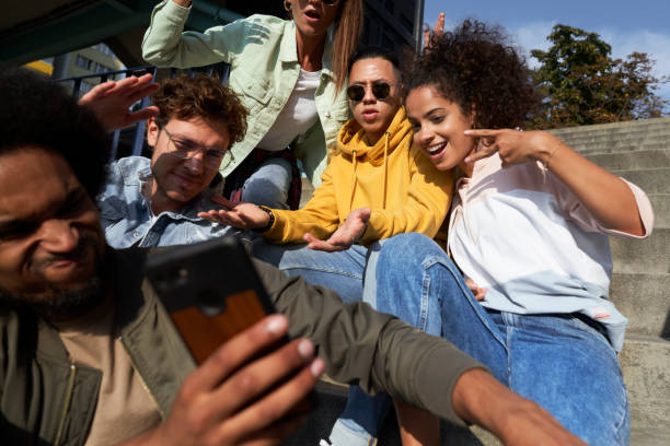 istock Young people gesturing and doing selfie together outdoors 1324190818