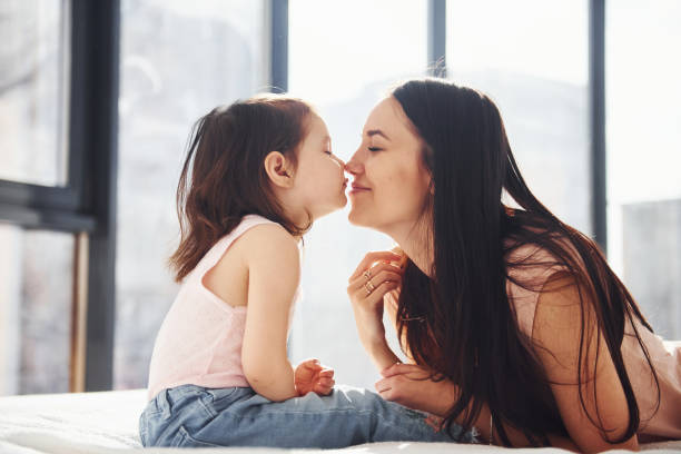 istock Young mother with her daughter embracing each other on bed 1324191076