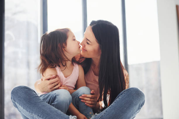 istock Young mother with her daughter embracing each other on bed 1324191121