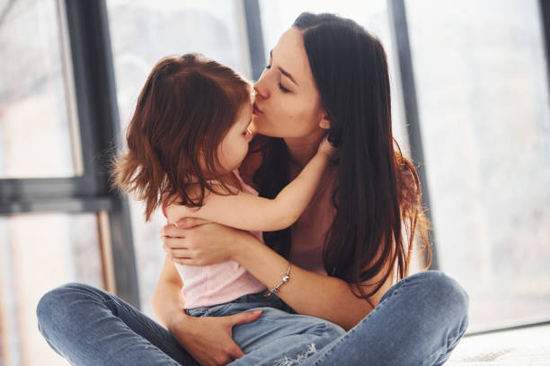 istock Young mother with her daughter embracing each other on bed 1324191180