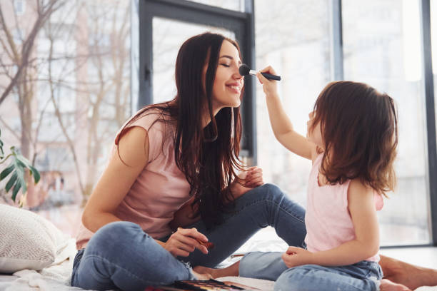istock Learning how to make up. Young mother with her daughter spending weekend together in room 1324191332