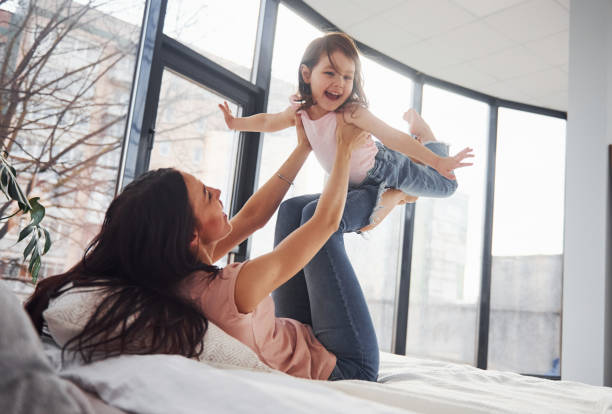 istock Young mother with her daughter spending weekend together on bed 1324191335