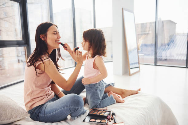 istock Learning how to make up. Young mother with her daughter spending weekend together in room 1324191361