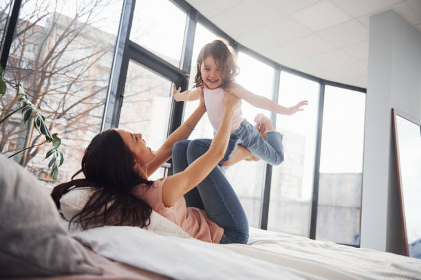 istock Young mother with her daughter spending weekend together on bed 1324191895