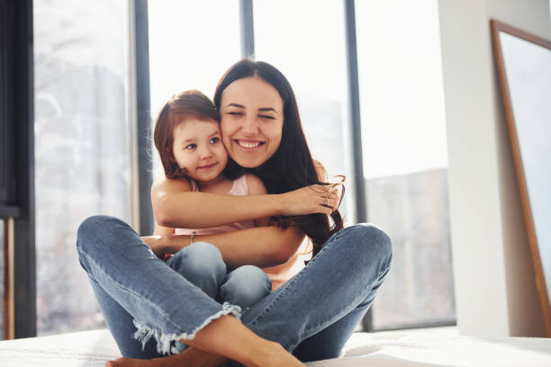 istock Young mother with her daughter embracing each other on bed 1324191920