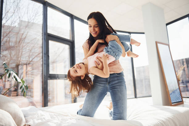 istock Young mother with her daughter spending weekend together on bed 1324191938