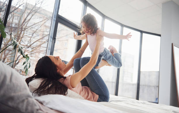 istock Young mother with her daughter spending weekend together on bed 1324191964