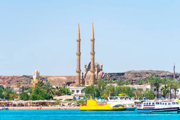 Photo of Al Mustafa Mosque in Old Town of Sharm El Sheikh, Egypt. One of the main tourist attraction with magnificent architecture. Blue sea in the foreground. View from the water