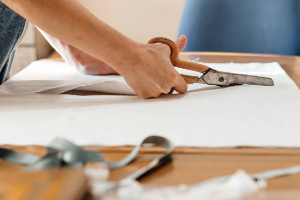 istock A needlewoman cuts fabric, a measuring tape for needlework, cutting and sewing with scissors 1324192689