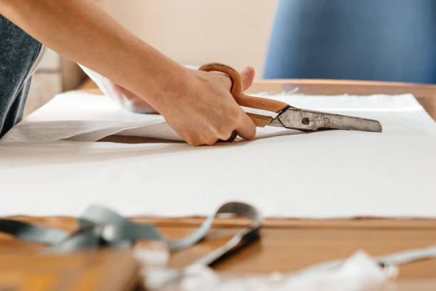 istock A needlewoman cuts fabric, a measuring tape for needlework, cutting and sewing with scissors. 1324193223