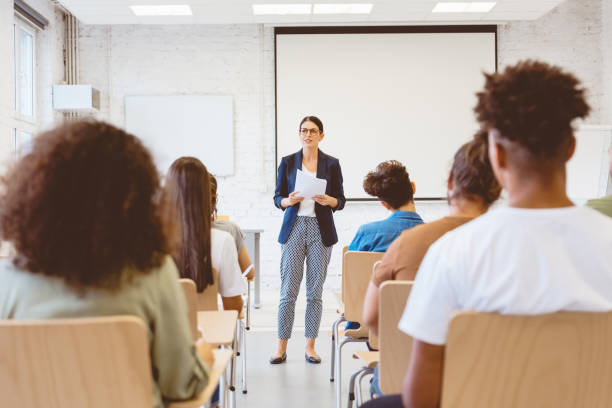istock Female professor giving speech at university 1324194457