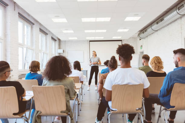 istock Female student giving presentation in classroom 1324194504