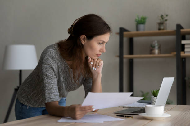 istock Confident businesswoman working with documents, looking at laptop screen 1324194581