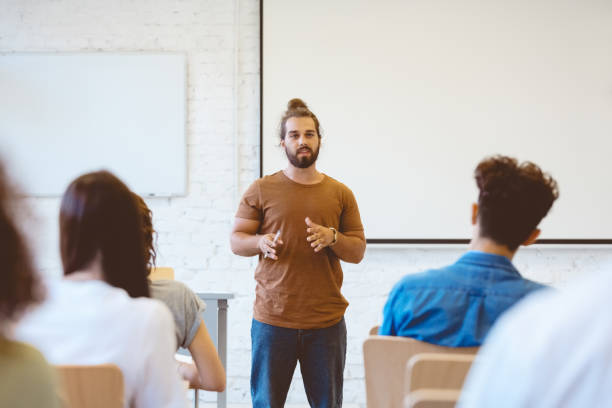 istock Male student giving presentation in seminar 1324194995