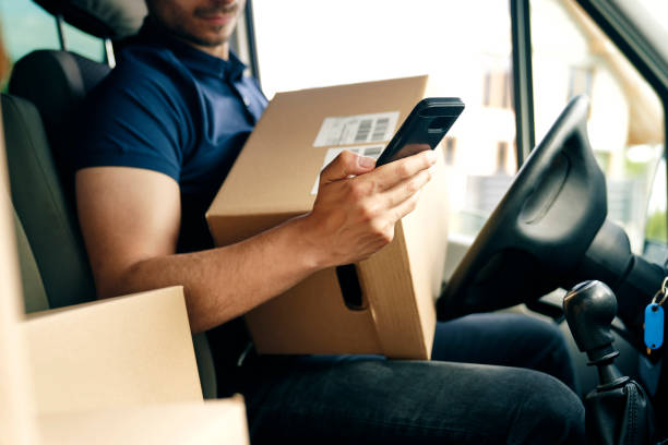 Close up of checking a package using portable information device stock photo