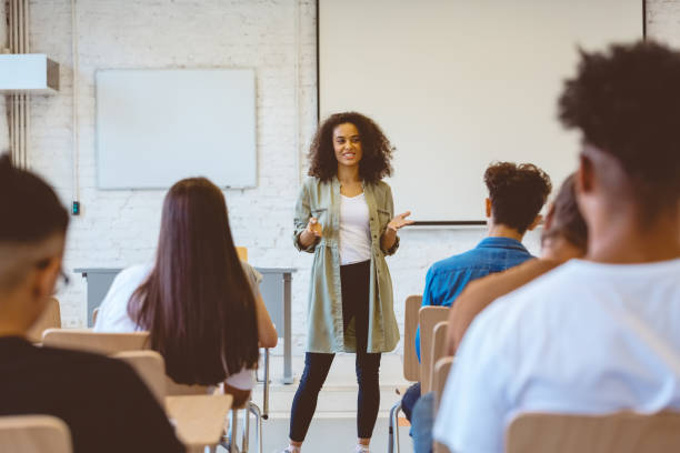 istock Woman sharing ideas with classmates in university 1324196305