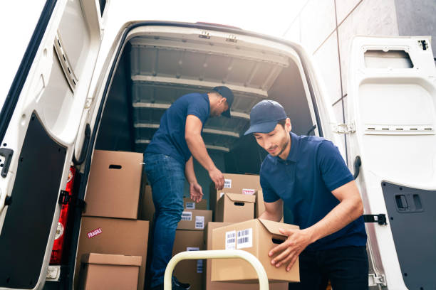 istock Bottom view of couriers unloading packages from a delivery truck 1324196399