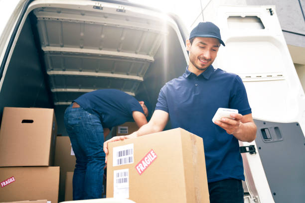 Bottom view of couriers unloading packages stock photo